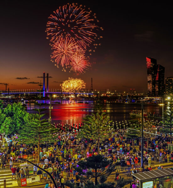 A wide shot showing the fireworks in the background over Docklands.