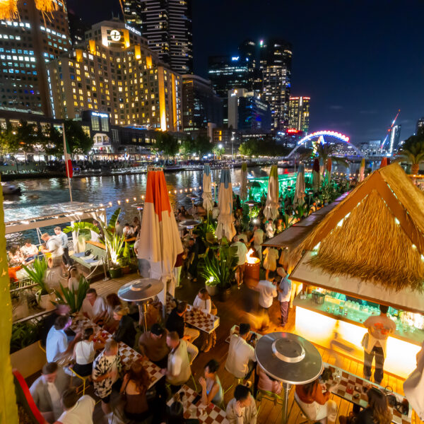 A wide shot of people at a bar with Southbank in the background